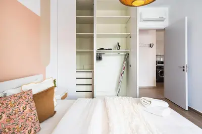 a small bedroom with a bed and a closet at Lunette - Artful 1-BR Apartment & Balcony in Larnaca in Larnaka