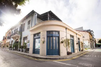 a white building with blue doors on a street at Atelier Residences by Sweet Keys in Limassol