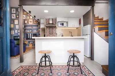a kitchen with a bar and two stools at Atelier Residences by Sweet Keys in Limassol