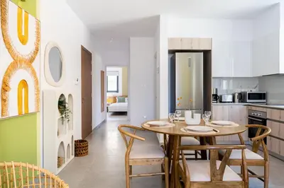 a kitchen and dining room with a table and chairs at Solenne - Stylish 2-BR Apartment & Balcony in Larnaca in Larnaka