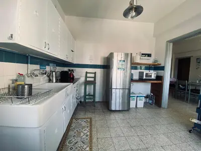 a kitchen with white cabinets and a refrigerator at Lima Sol House in Limassol