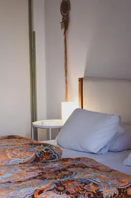 a bedroom with two beds and a side table at Lima Sol House in Limassol