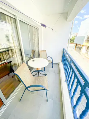 a patio with a table and chairs on a balcony at Awaken Your Divine Self Sacred Self Discovery Retreat in Ayia Napa Cyprus in Ayia Napa