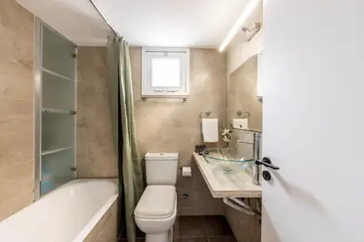 a bathroom with a toilet and a tub and a sink at Larnaca Seaside Villa Marina 43 in Pervolia