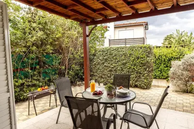 a patio with a table and chairs on a patio at Larnaca Seaside Villa Marina 43 in Pervolia