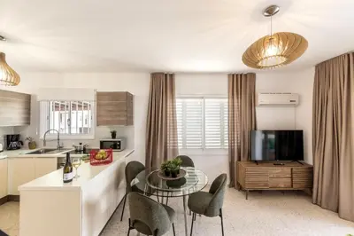 a kitchen and living room with a table and chairs at Larnaca Seaside Villa Marina 43 in Pervolia