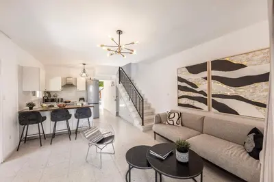 a living room with a couch and a kitchen at Larnaca Seaside Villa Marina 44 in Pervolia