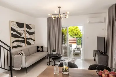 a living room with a couch and a table at Larnaca Seaside Villa Marina 44 in Pervolia