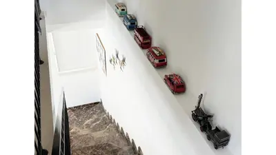 a staircase with toy cars on the wall at Bow Villa in Paralimni