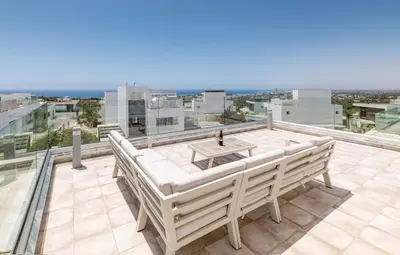a white bench sitting on top of a roof at Elite Blu Heights Villa in Ayia Napa