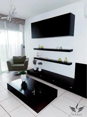 a living room with a flat screen tv on the wall at Ikarus in Limassol