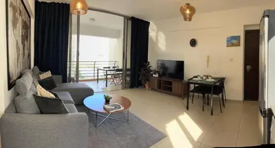 a living room with a couch and a table at Makriev Suite in Larnaka