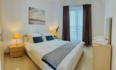 a bedroom with a large bed and a window at Makriev Suite in Larnaka