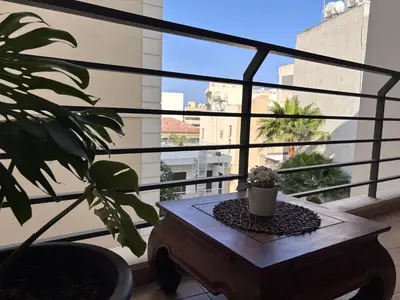 a balcony with a table and a potted plant at Makriev Suite in Larnaka