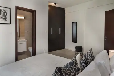 a bedroom with a white bed and a bathroom at Phaedrus Living Travertine Residences 101 in Strovolos