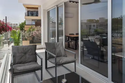 two chairs sitting on the balcony of a house at Phaedrus Living Travertine Residences 101 in Strovolos