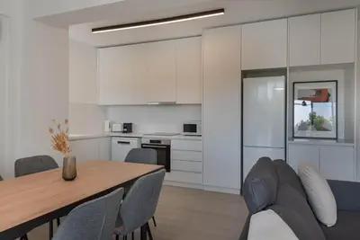 a kitchen and dining room with a table and chairs at Phaedrus Living Travertine Residences 101 in Strovolos