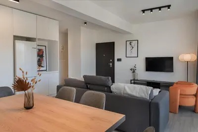 a living room with a couch and a table at Phaedrus Living Travertine Residences 101 in Strovolos