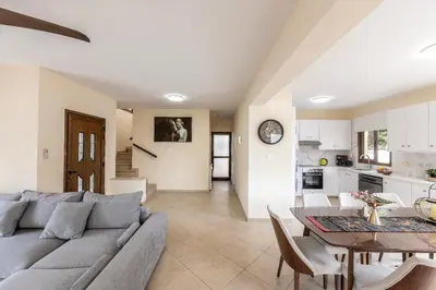 a living room with a couch and a table at Villa Poseidon in Paralimni