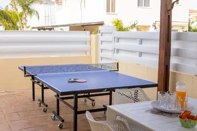 a blue ping pong table on a patio at Villa Poseidon in Paralimni