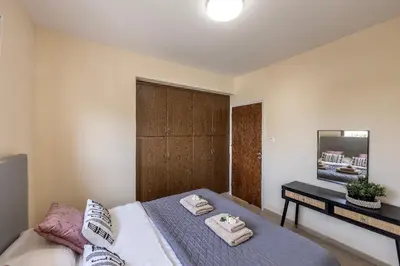 a bedroom with a bed with towels on it at Villa Poseidon in Paralimni