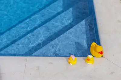 two rubber ducks sitting next to a swimming pool at Villa Poseidon in Paralimni
