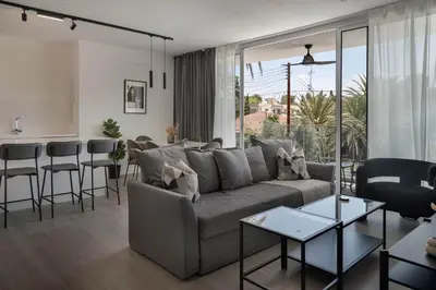 a living room with a couch and a table at Phaedrus Living Travertine Residences 102 in Strovolos
