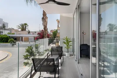 a balcony of a house with chairs and plants at Phaedrus Living Travertine Residences 102 in Strovolos