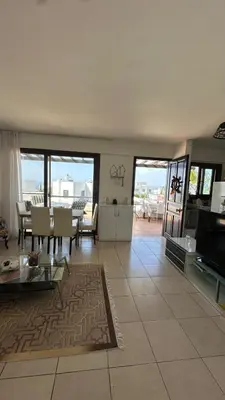 a living room with a table and a dining room at Kyrenia 2 bedroom apartment in Ayios Dhometios