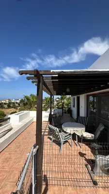 a patio with a table and chairs on a roof at Kyrenia 2 bedroom apartment in Ayios Dhometios