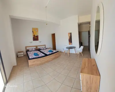 a bedroom with a bed and a table and chairs at Pergamonto Apartments in Ayia Napa
