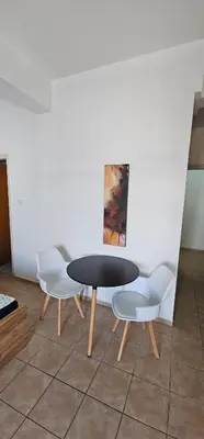 a table and two chairs in a room at Pergamonto Apartments in Ayia Napa