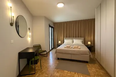 a bedroom with a bed and a desk and a mirror at Kallisti 2bd Central Stay - Wow View in Nicosia