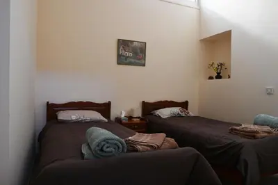 a bedroom with two beds and a window at ThemisHouse in Omodos