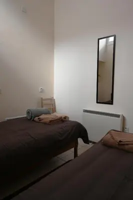 a bedroom with two beds and a mirror on the wall at ThemisHouse in Omodos
