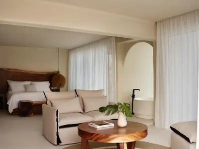 a living room with a couch and a bed at Aya Resort - Adults Only in Ayia Napa