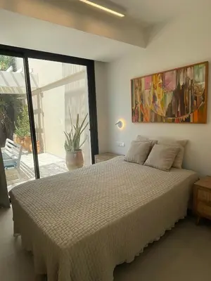 a bedroom with a bed and a large window at Tiffany Mare villa in Ayia Napa