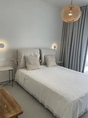 a white bed with two pillows in a bedroom at Tiffany Mare villa in Ayia Napa