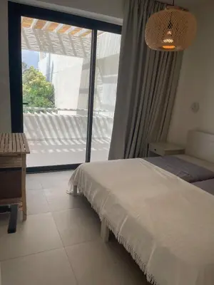 a bedroom with a bed and a large window at Tiffany Mare villa in Ayia Napa
