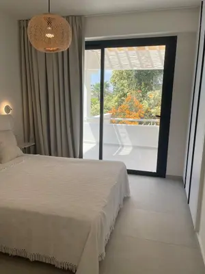 a bedroom with a bed and a large window at Tiffany Mare villa in Ayia Napa