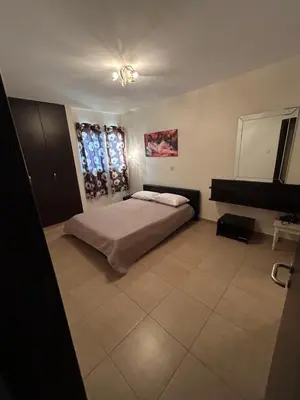 a bedroom with a bed and a window at Modern 2BR Appartment near Finikoudes beach - Larnaka in Larnaka