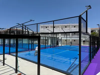 a tennis court with two people on the court at Sun & Sea House in Paralimni