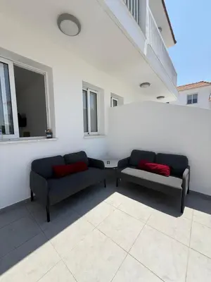 two couches sitting in a room in a building at Sun & Sea House in Paralimni