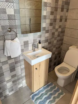 a bathroom with a sink and a toilet at Sun & Sea House in Paralimni