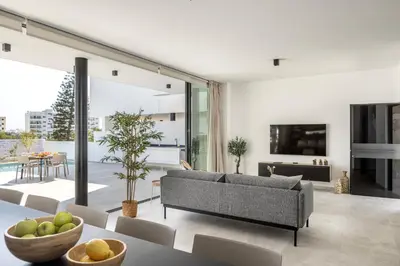 a living room with a couch and a table at Protaras Aqua Pearl Villa 3 in Protaras