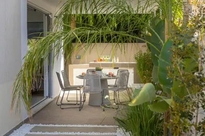 a patio with a table and chairs on it at Protaras El Sol Villa in Protaras