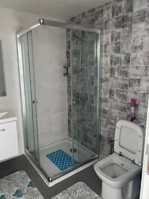a bathroom with a shower and a toilet at Abelia Sea View in Paralimni