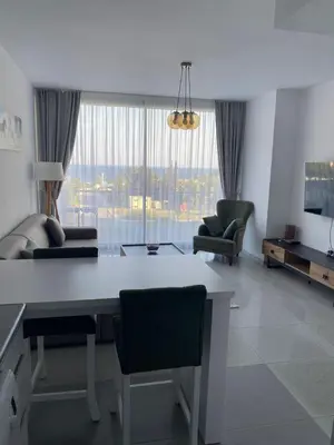 a living room with a table and chairs and a couch at Abelia Sea View in Paralimni