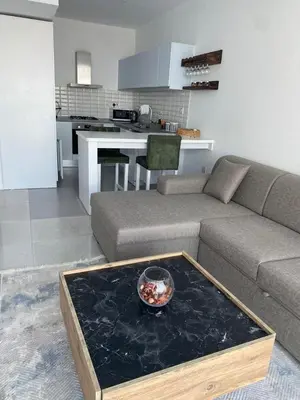 a living room with a couch and a table at Abelia Sea View in Paralimni