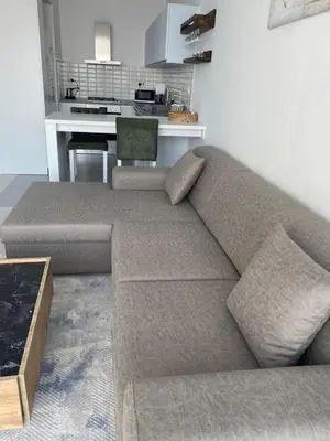 a couch sitting in a living room with a table at Abelia Sea View in Paralimni